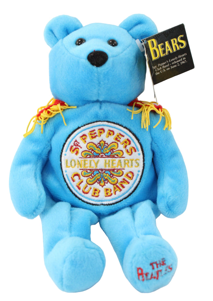 Blue teddy bear with Sgt. Pepper's Lonely Hearts Club Band design on a white background