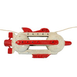 Toy rocket on a string against a white background