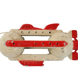 Toy rocket with red and beige design on a white background