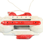 Vintage toy with red and white design on a white background