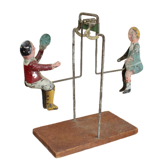Vintage toy figure on a stand with a white background