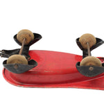 Vintage-style red metal tool with wooden handles on a white background