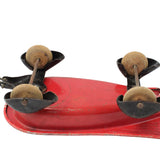 Vintage-style red metal tool with wooden handles on a white background