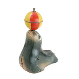 Seal figurine with a colorful ball on its head against a white background