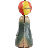 Toy figure of a clown with a red nose and colorful outfit on a white background