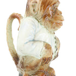 Decorative shell with a white center and brown and green edges on a white background