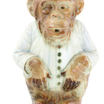 Carved stone figure of a face on a white background