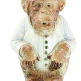 Carved stone figure of a face on a white background