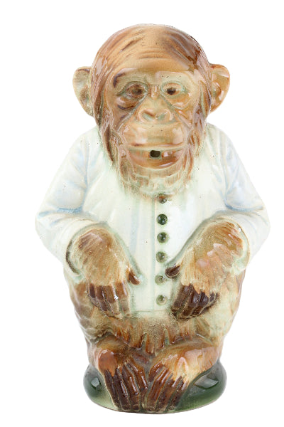 Carved stone figure of a face on a white background