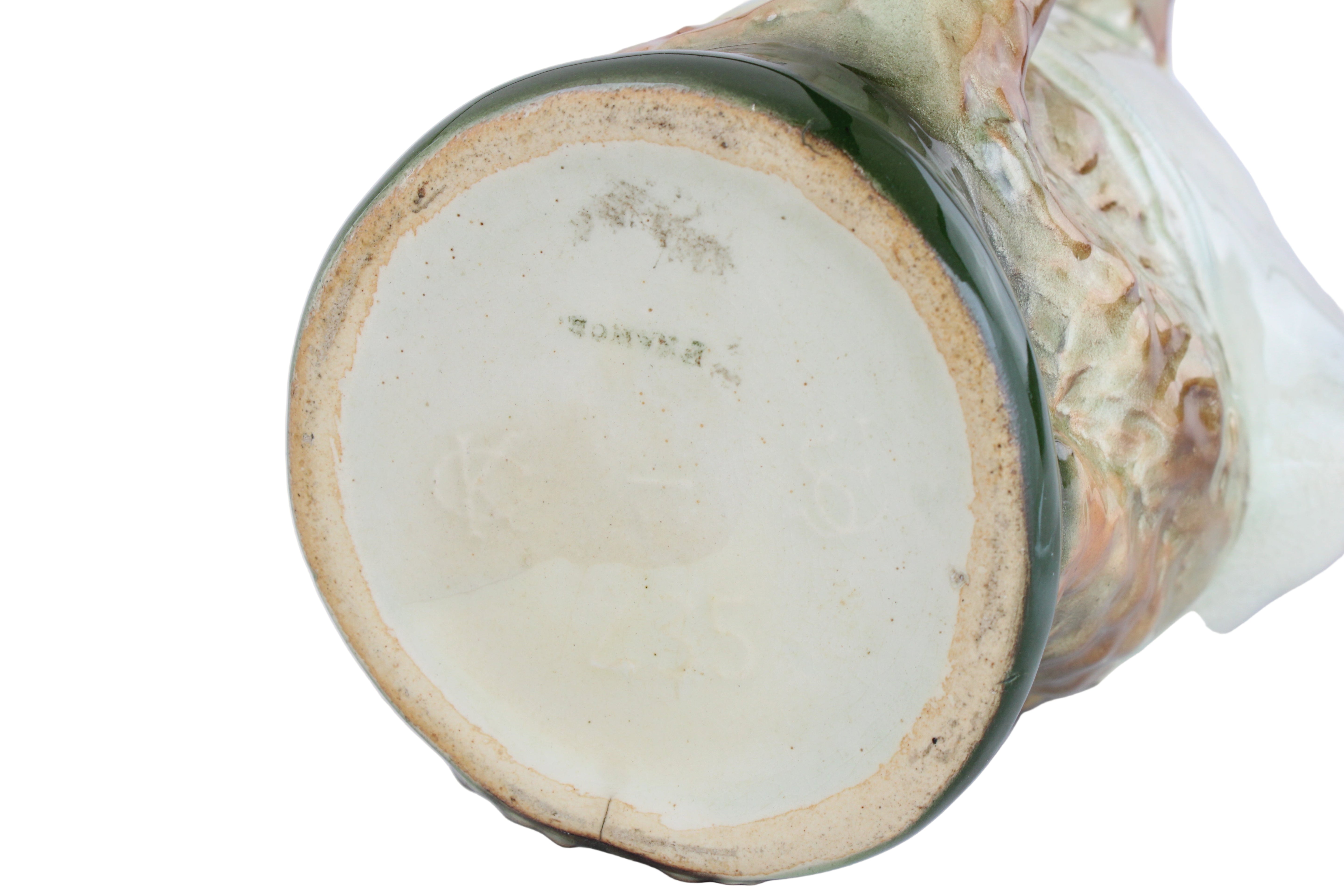 Close-up of a ceramic vase with a textured surface on a white background