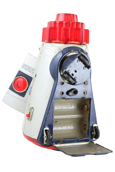 Vintage toy drill with red handle and buttons on a white background