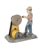 Vintage toy figure of a worker operating a machine on a white background