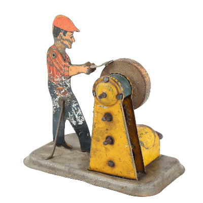 Vintage-style toy figure of a man operating a machine on a white background
