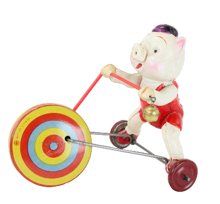 Toy figure of a pig riding a tricycle with colorful wheels on a white background
