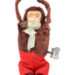 Stuffed monkey toy with a white hat and red pants on a white background