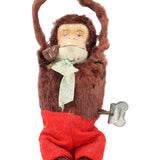 Stuffed monkey toy with a white hat and red pants on a white background