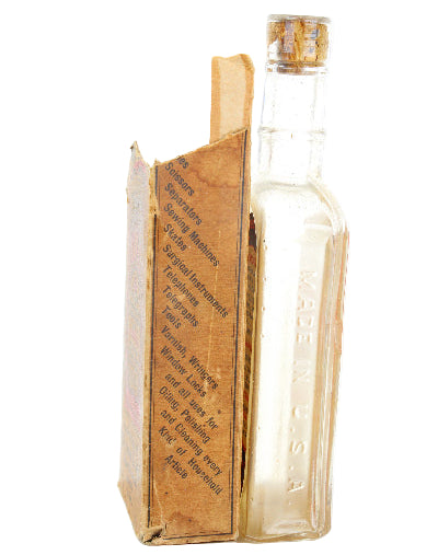 Clear glass bottle with a book-shaped label on a white background