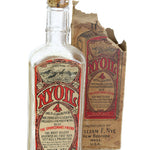 Vintage Wills bottle with a crumpled label on a white background