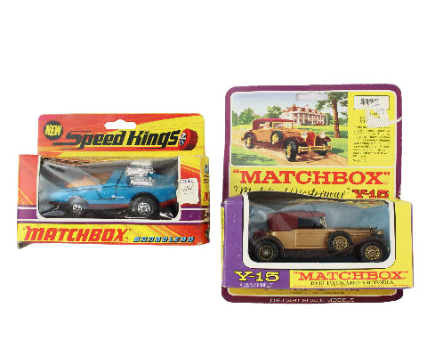 Two vintage Matchbox toy cars in their original packaging on a white background