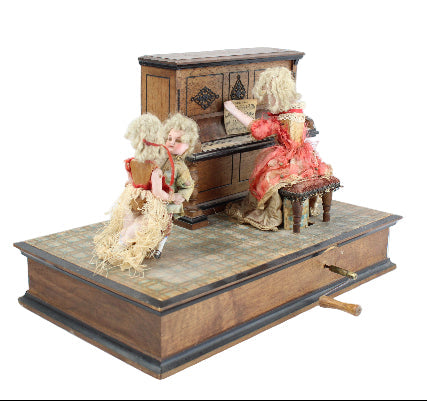 Miniature wooden stage with dolls and furniture on a white background