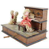 Miniature doll playing a piano with two dolls watching on a white background