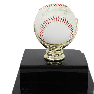 Signed baseball on a black base with gold stand against a white background
