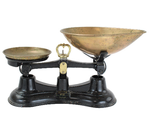 Vintage scale with brass bowls on a white background