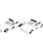 Two toy police cars on a white background
