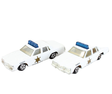 Two toy police cars on a white background