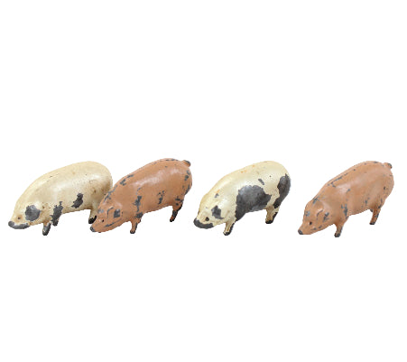 Four small pig figurines on a white background
