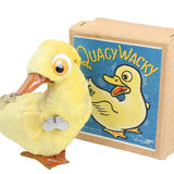 Yellow duck toy with a box labeled 'Quacy Wacky' on a white background