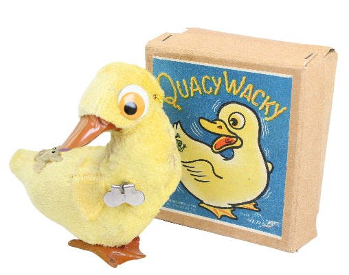 Yellow duck toy with a box labeled 'Quacy Wacky' on a white background