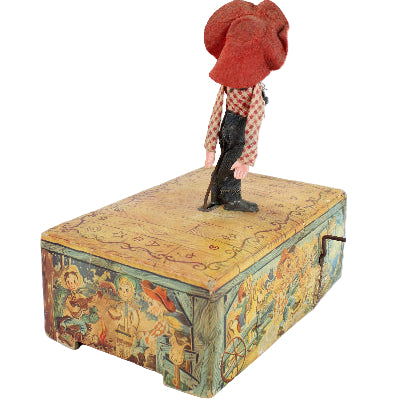 Small figurine standing on a decorative box with a map design on a white background