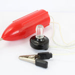 Red plastic float, clear light bulb, and black alligator clips on a white background