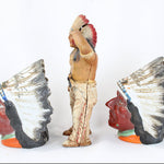 Three Native American figurines with headdresses on a white background