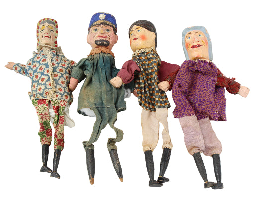 Four vintage dolls in different outfits on a white background