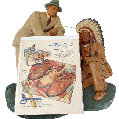 Decorative Native American figurines with a vintage-style shoe advertisement on a white background