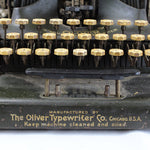 Vintage typewriter with 'The Oliver Typewriter Co. Chicago, U.S.A.' branding on a white background