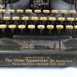 Vintage typewriter with 'The Oliver Typewriter Co. Chicago, U.S.A.' branding on a white background