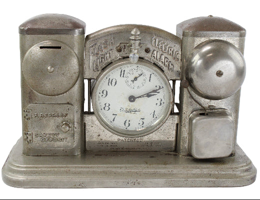 Vintage electric alarm clock with savings bank on a white background