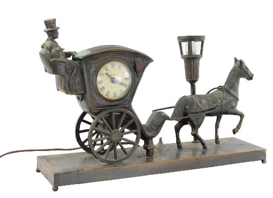 Decorative clock with horse and carriage design on a white background