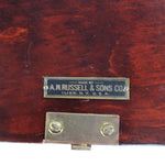 Wooden box with a brass latch and label on a white background