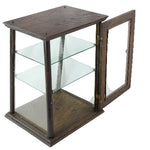 Glass display case with wooden frame on a white background