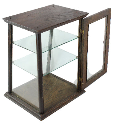 Glass display case with wooden frame on a white background