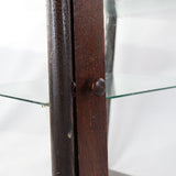 Close-up of a wooden object with a glass surface in the background