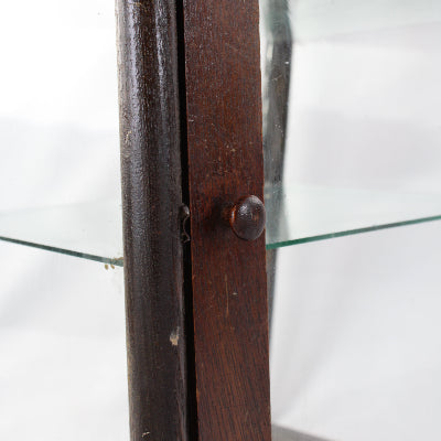 Close-up of a wooden object with a glass surface in the background