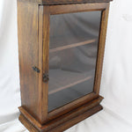 Wooden display case with glass door on a white background