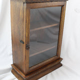 Wooden display case with glass door on a white background