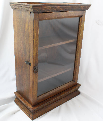 Wooden display case with glass door on a white background