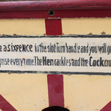 Sign on a mechanical device with text about placing a sixpence for a surprise.